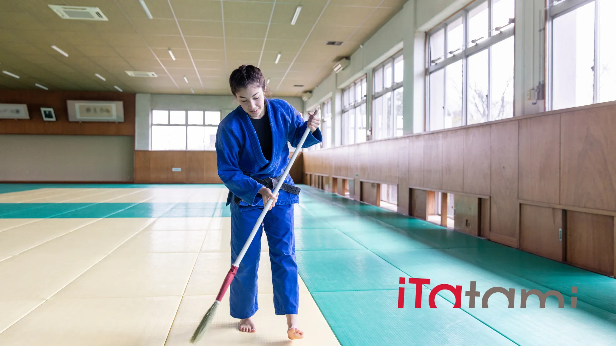 person who is cleaning sports tatami