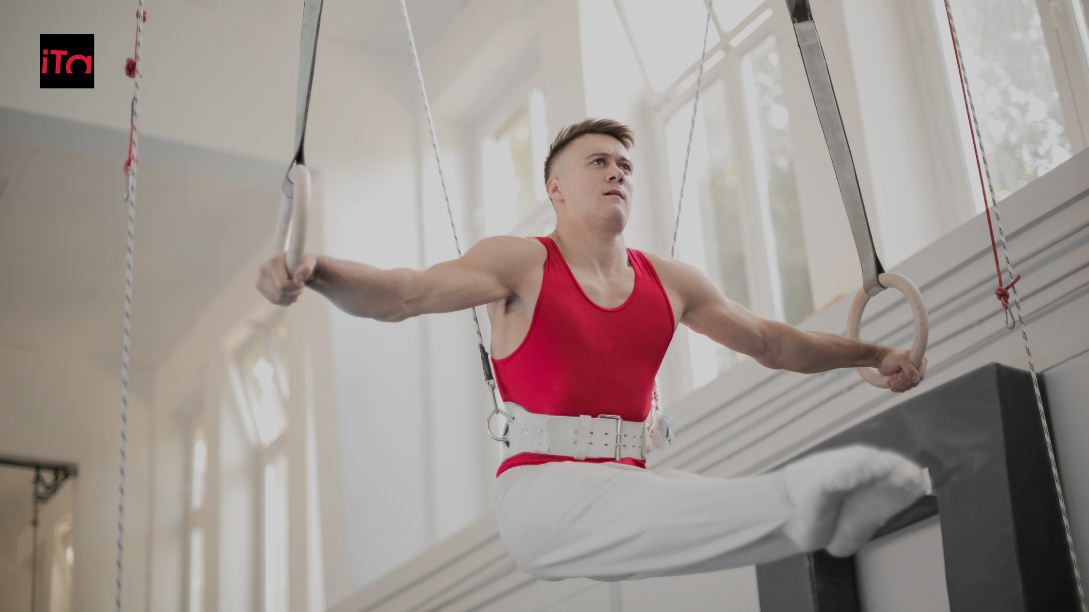 Person training in an artistic gymnastics gym with Bortolotto mattresses